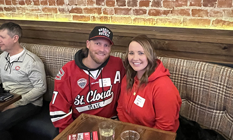 A couple Huskies fans sit at a table