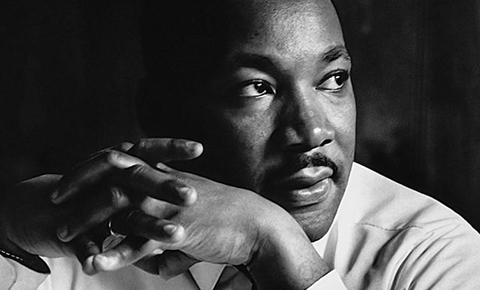 A black and white portrait of Dr. Martin Luther King Jr.