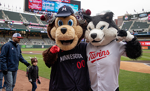 The Twins and Huskies mascots pose for a photo