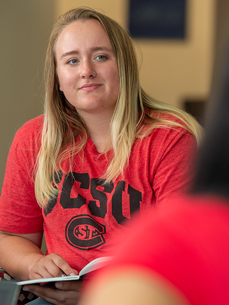 Female student looking intently at person across from her