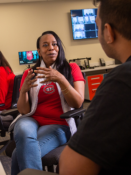 Professor talking to student in observation room