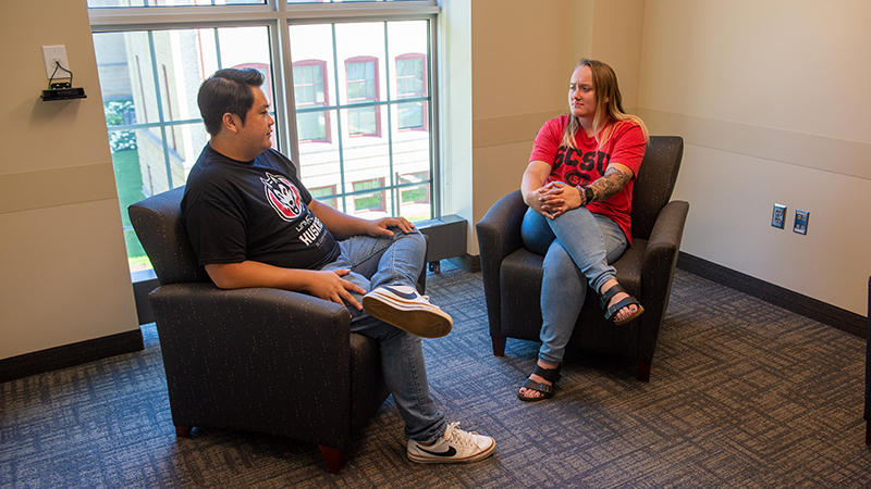 Two students seated in counseling suite