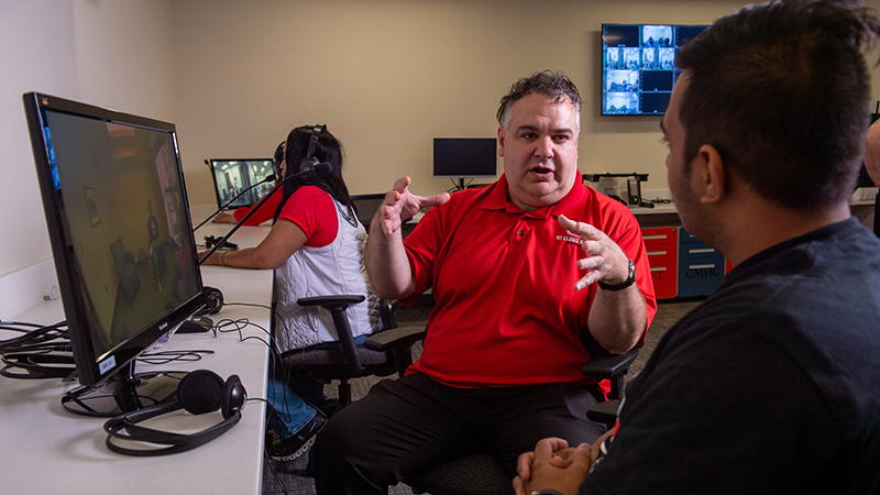 Professor talking to student in observation room