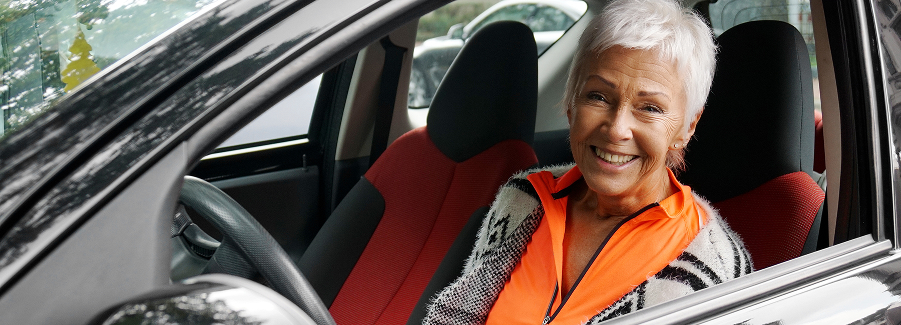 Older female driver sitting in car