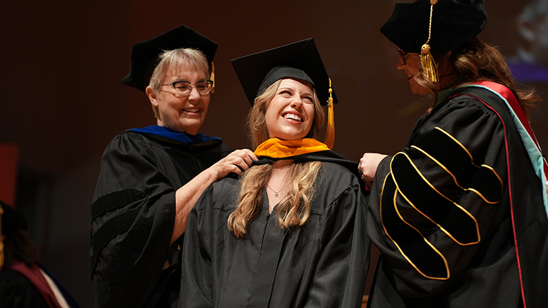 Graduate hooded by professors