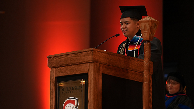 Student graduate speaks at podium