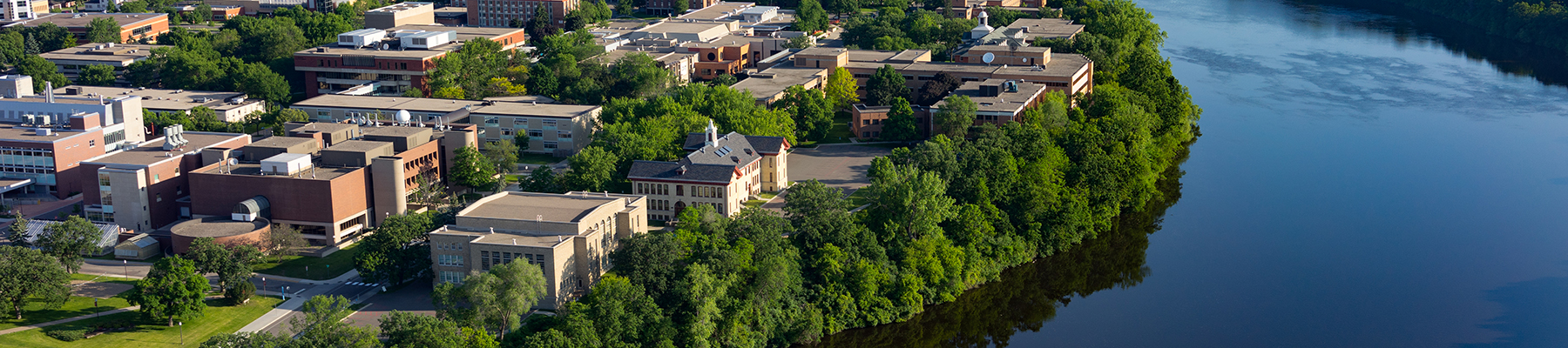 Aerial view of campus by river