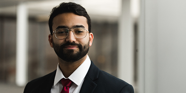 Young man in suit looking at camera