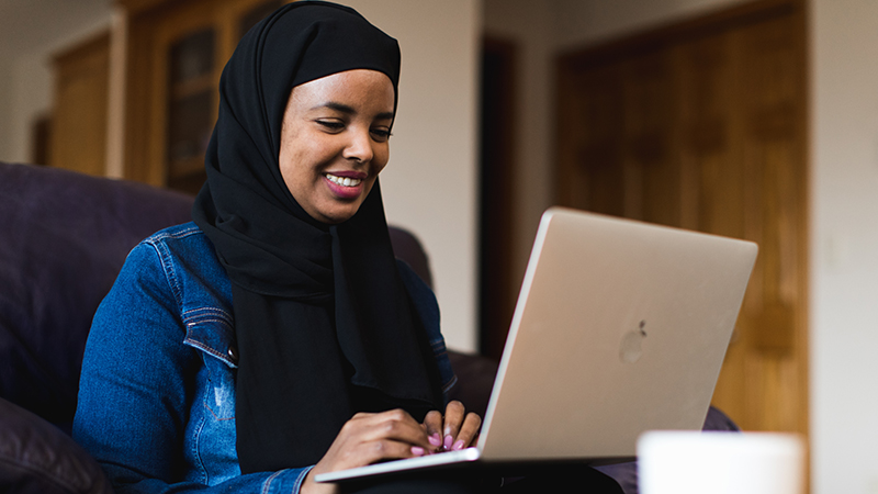 Female student working on laptop from home