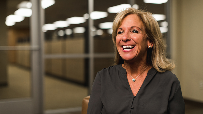 Woman in conference room smiling across the room