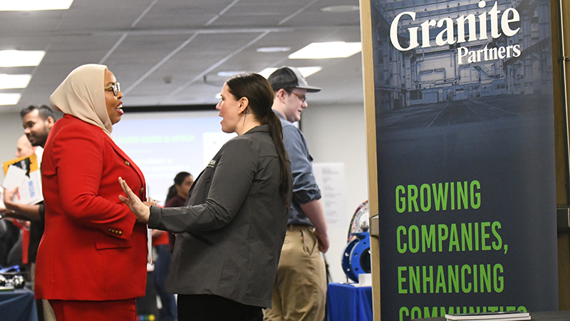 A student and recruiter talking at job fair