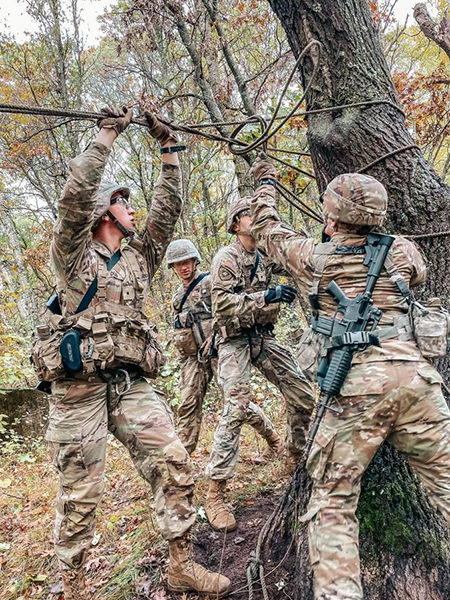 Group of cadets tying rope around a tree