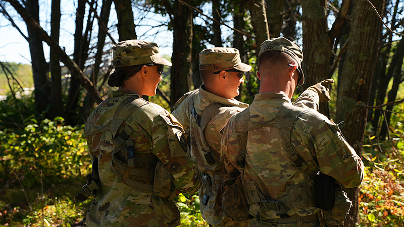 Three ROTC students looking into the distance outdoors