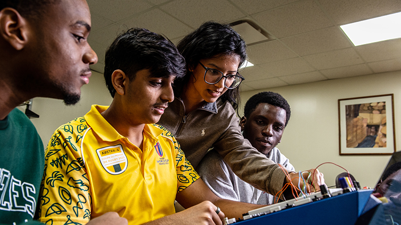 Computer Science students looking at equipment