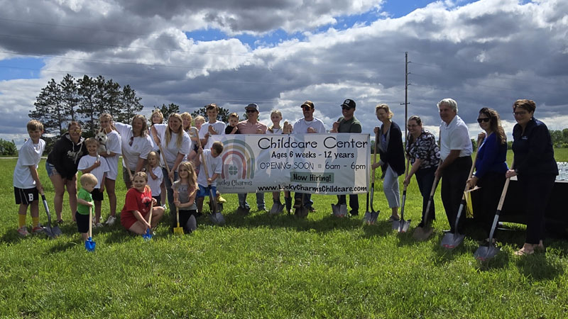 Ribbon cutting ceremony in grass field