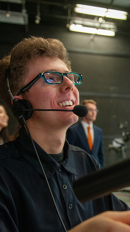 Student operating a tv studio camera