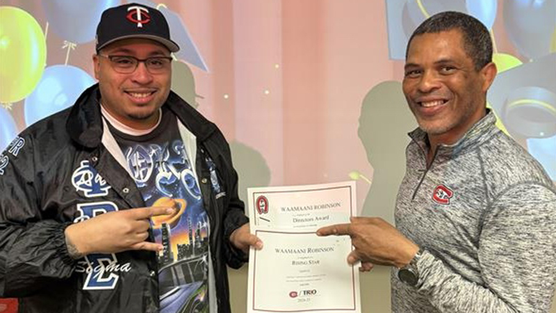 Student receiving achievement award from TRIO director