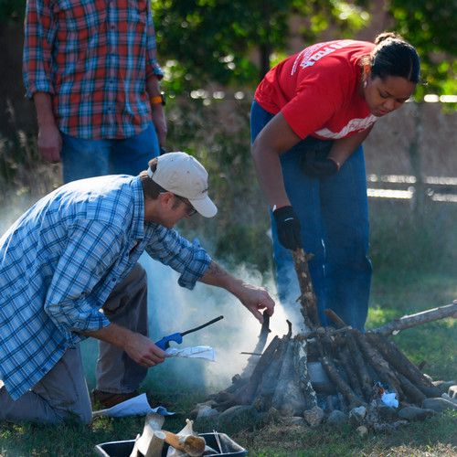 Professor and student tend to a fire