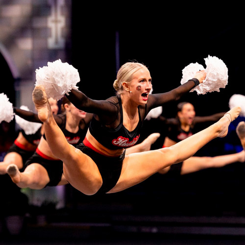 SCSU dancers leap into the air during a routine