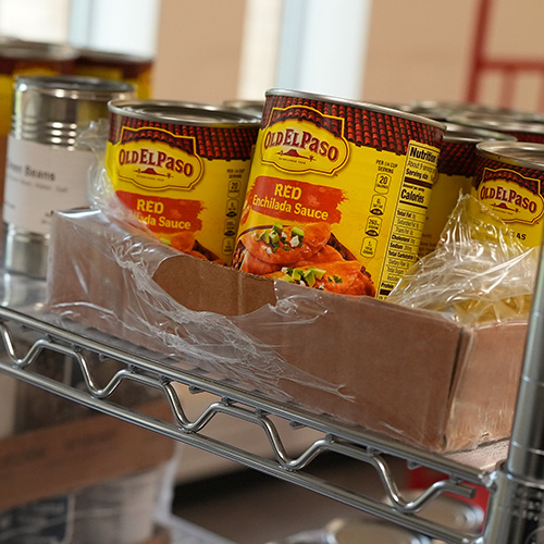 A stack of cans on a shelf