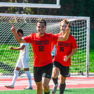 Two SCSU soccer players celebrate a goal