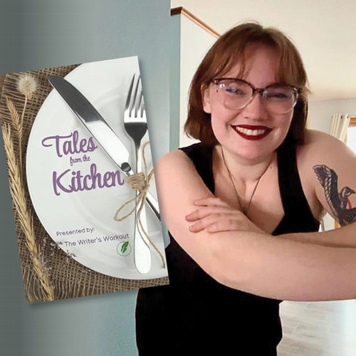 A woman smiles for a photo next to a book