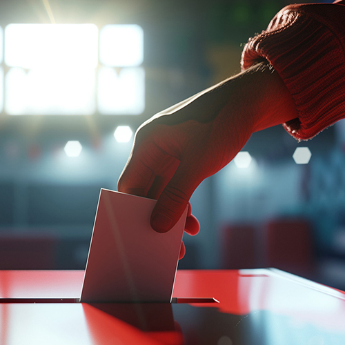 Hand placing ballot into box